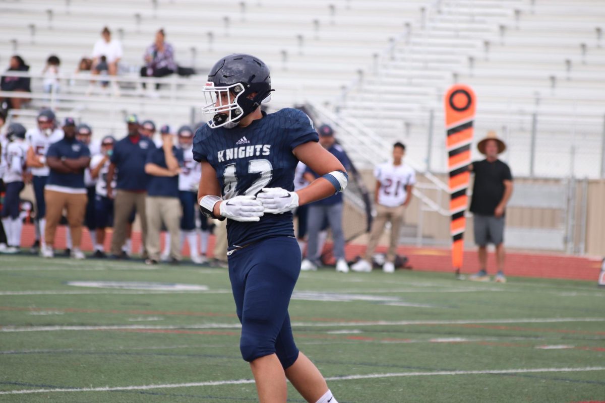 San Marcos High School varsity football player in the middle of a game.