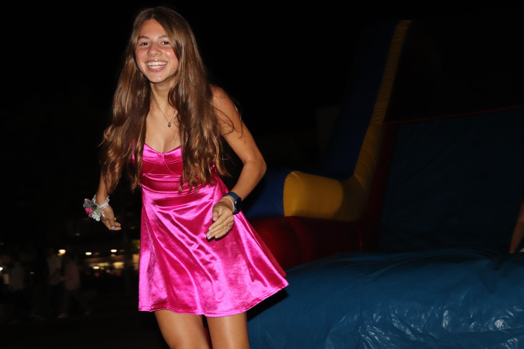 Photo taken at homecoming on Oct. 7. Student smiling after getting off of the inflatable slide.