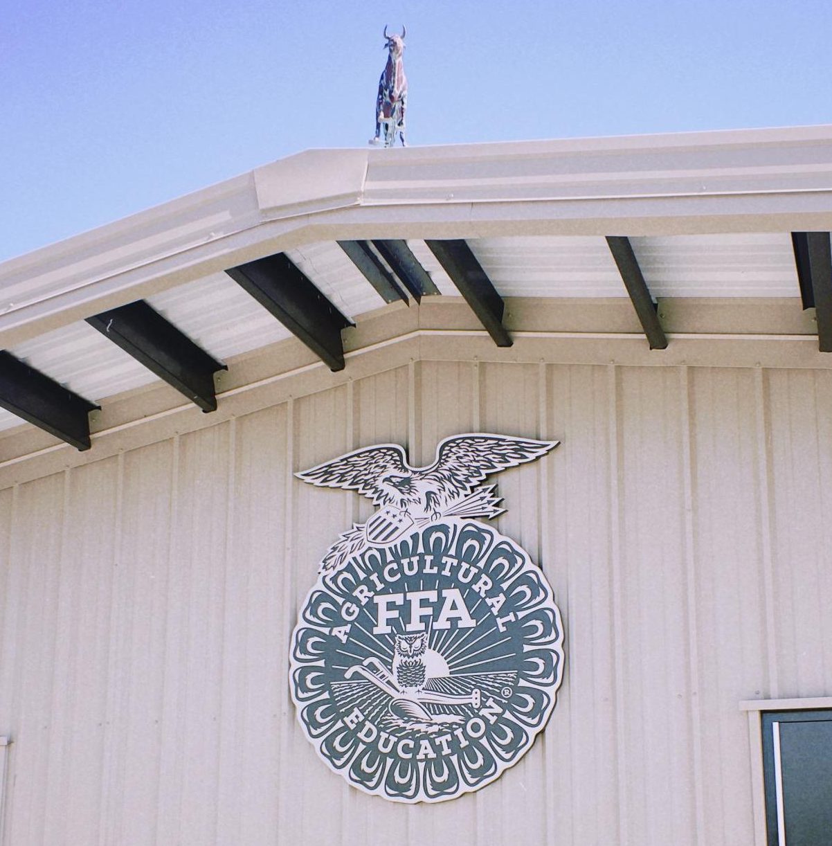 The cow barn in the FFA farm introduces visitors will  large seal stating Agricultural FFA Education.