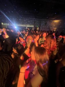 Photo captured in the CSUSM ballroom during Winter Formal of students dancing.