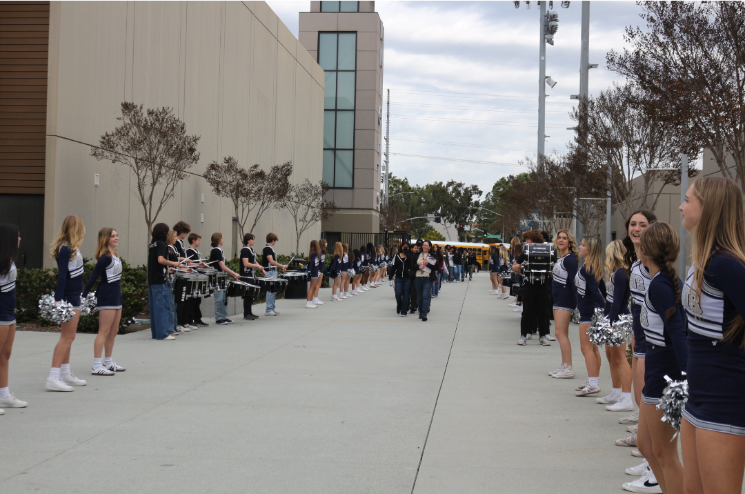 8th graders being welcomed into campus by the marching band and cheerleaders.