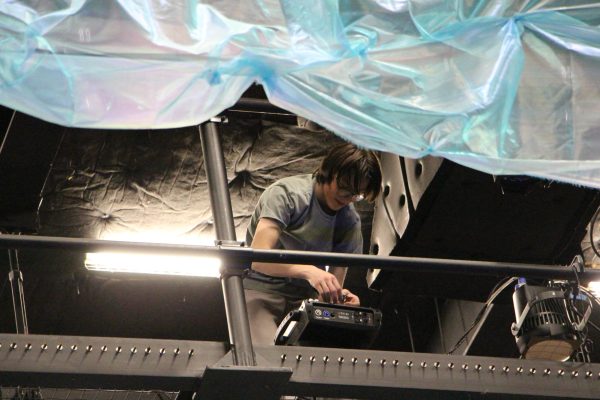 Lighting operator, Samuel Gordon working behind the scenes during the production of The Little Mermaid. (Sophia Pedroza)